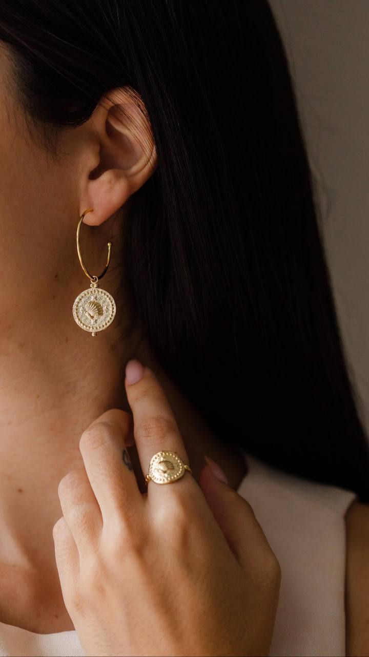 Elevate your summer style with our Hoops with Sea Shell Charm Earrings, capturing the essence of beach chic elegance.